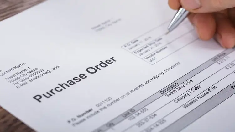 Warehouse manager checking delivered goods against a purchase order